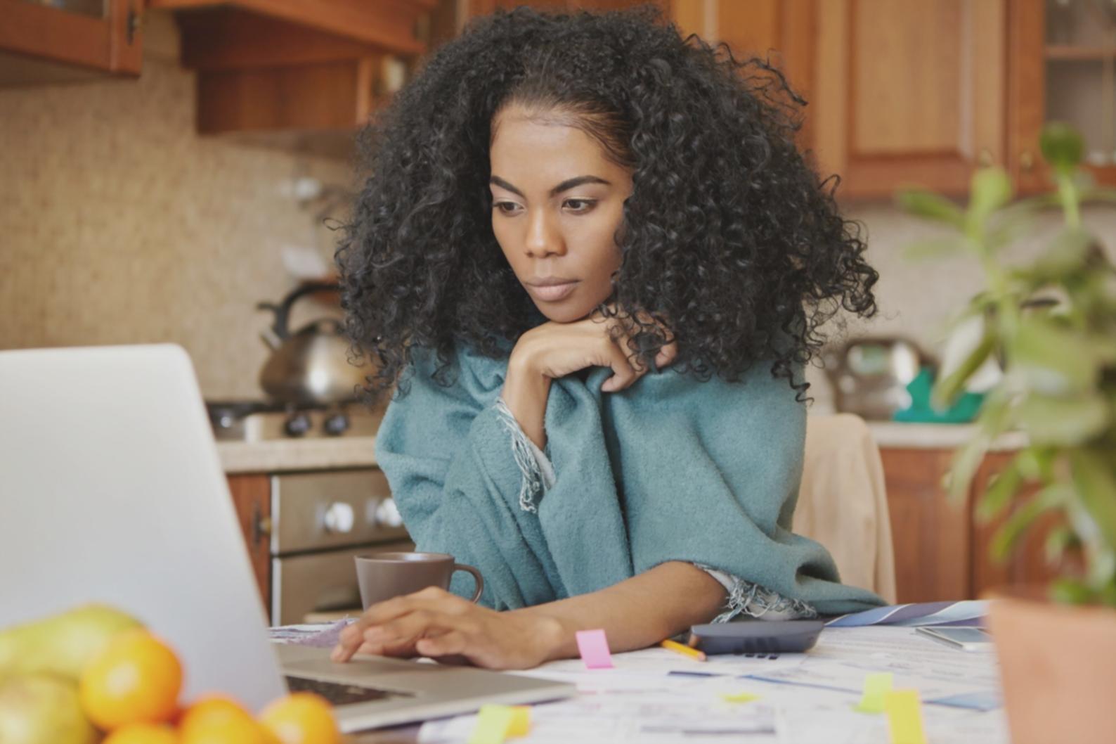 Financial consultant reviewing budget spreadsheets and planning documents with calculator