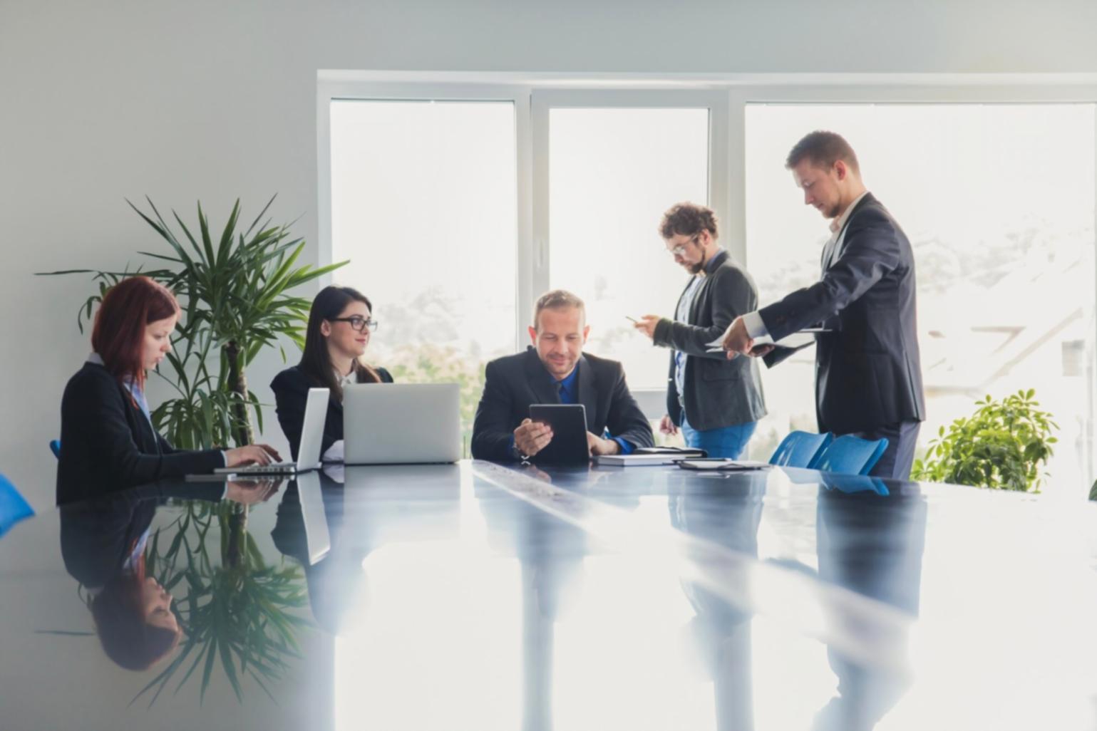 Group of people collaborating in a modern workshop setting, discussing financial planning strategies together